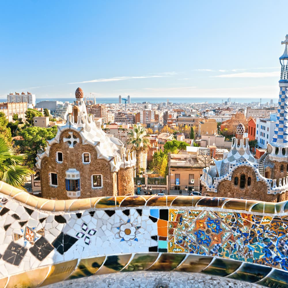 Panoramic view of Barcelona from Park Güell with Gaudí architecture and Mediterranean Sea in the background
